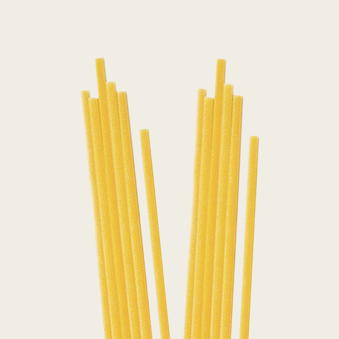 Yellow spaghetti strands on a light beige background