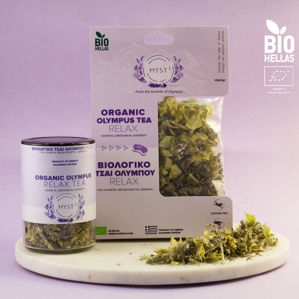 Organic Olympus Tea packaging and loose tea on a marble board with a purple background