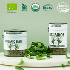 Two jars of organic Greek basil with labels and certification logos on a light green background.