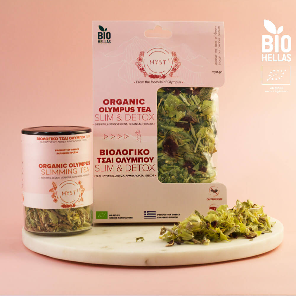 Organic Olympus tea packaging and loose tea leaves on a pink background