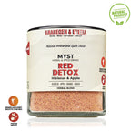 Glass container of 'Red Detox' herbal blend with label on a white background