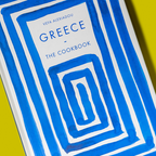 Book titled 'Greece: The Cookbook' by Phaidon on a yellow background