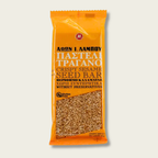 Packaged snack bar with sesame seeds on an orange background