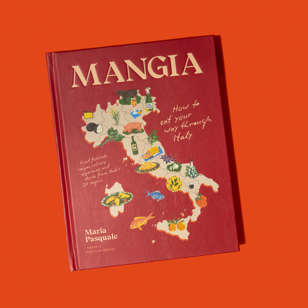 Book titled 'MANGIA' with a map of Italy on the cover against an orange background