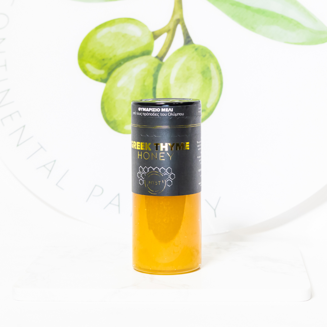 Greek Thyme Honey bottle with green grapes in the background