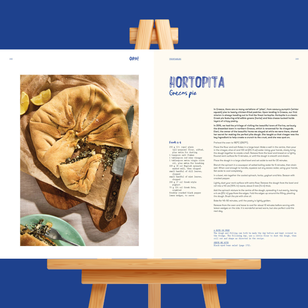 Hortopita pie on a wooden board with a recipe card on an easel