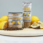 Sea salt blend with lemon and pepper packaging on a wooden board with lemons.