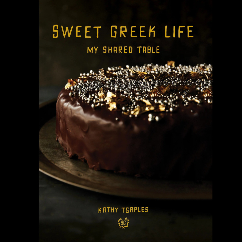 Chocolate cake with decorative elements on a dark background, featuring text 'Sweet Greek Life' and 'My Shared Table' by Kathy Tsaples.