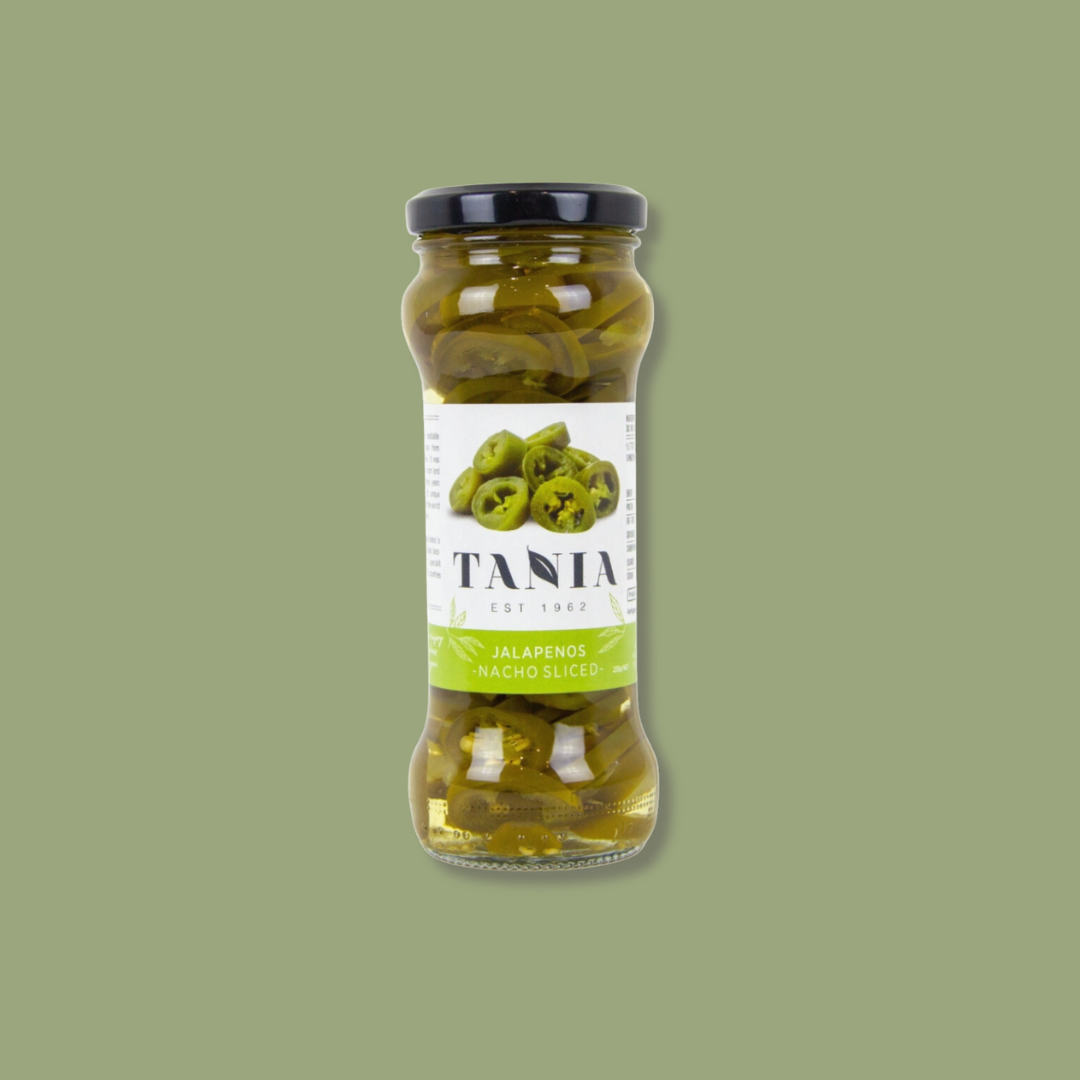 Jar of Tania jalapeños on a green background