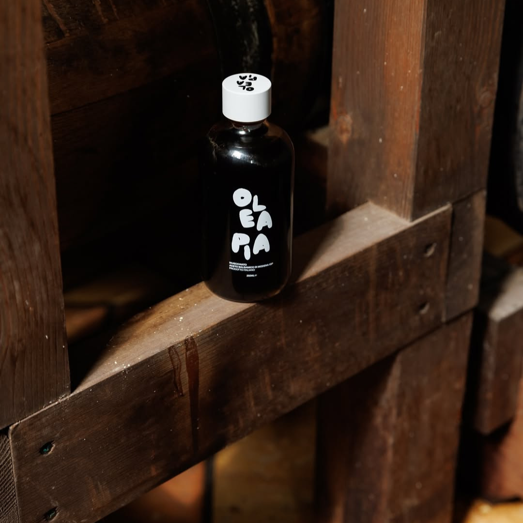 Black bottle with white label on a wooden surface