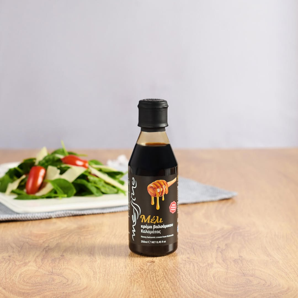 Bottle of Mel honey on a wooden table with a salad in the background
