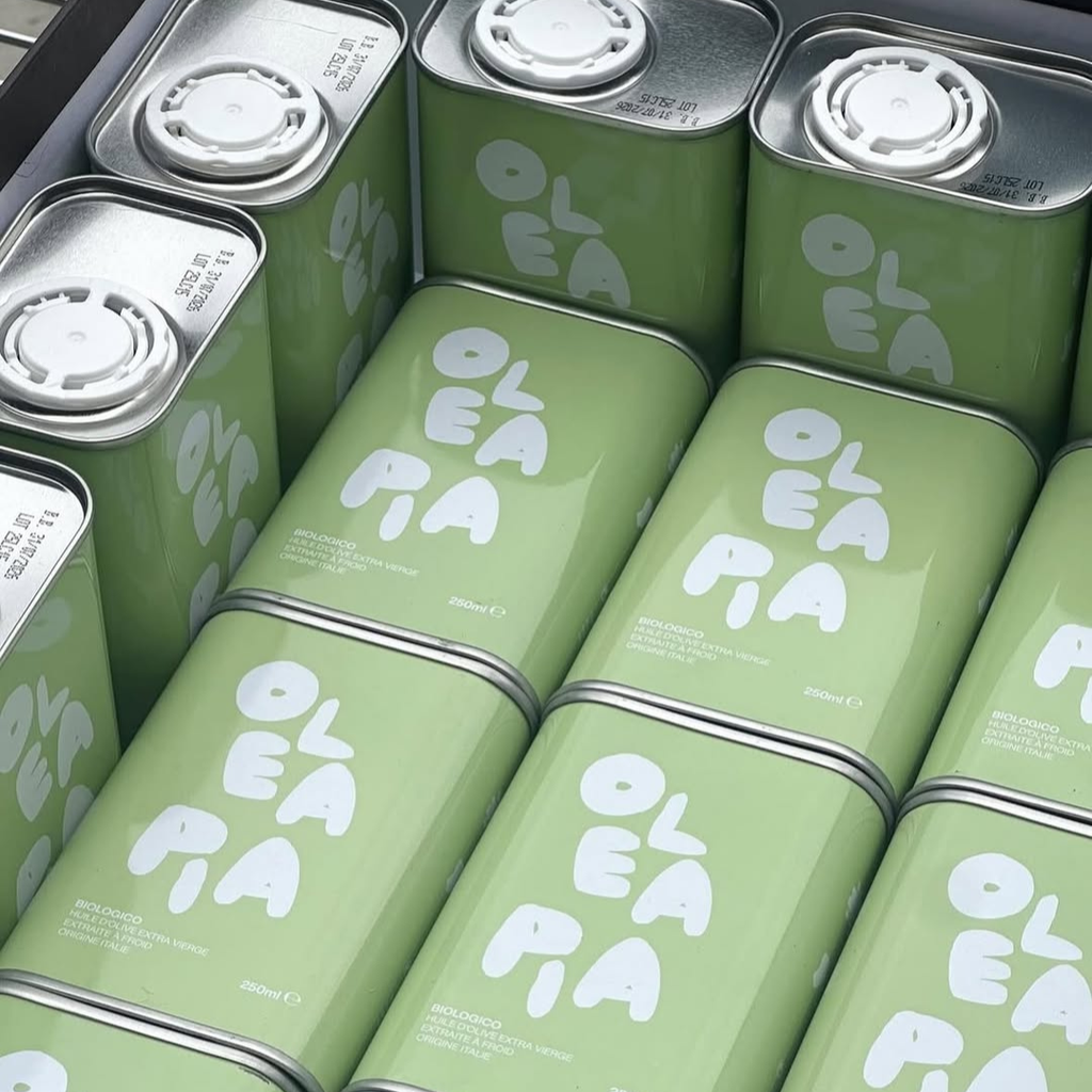 Green tins with 'Olea' branding stacked together