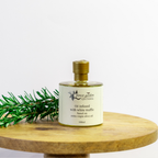 Bottle of oil infused with white truffle on a wooden surface with a white background