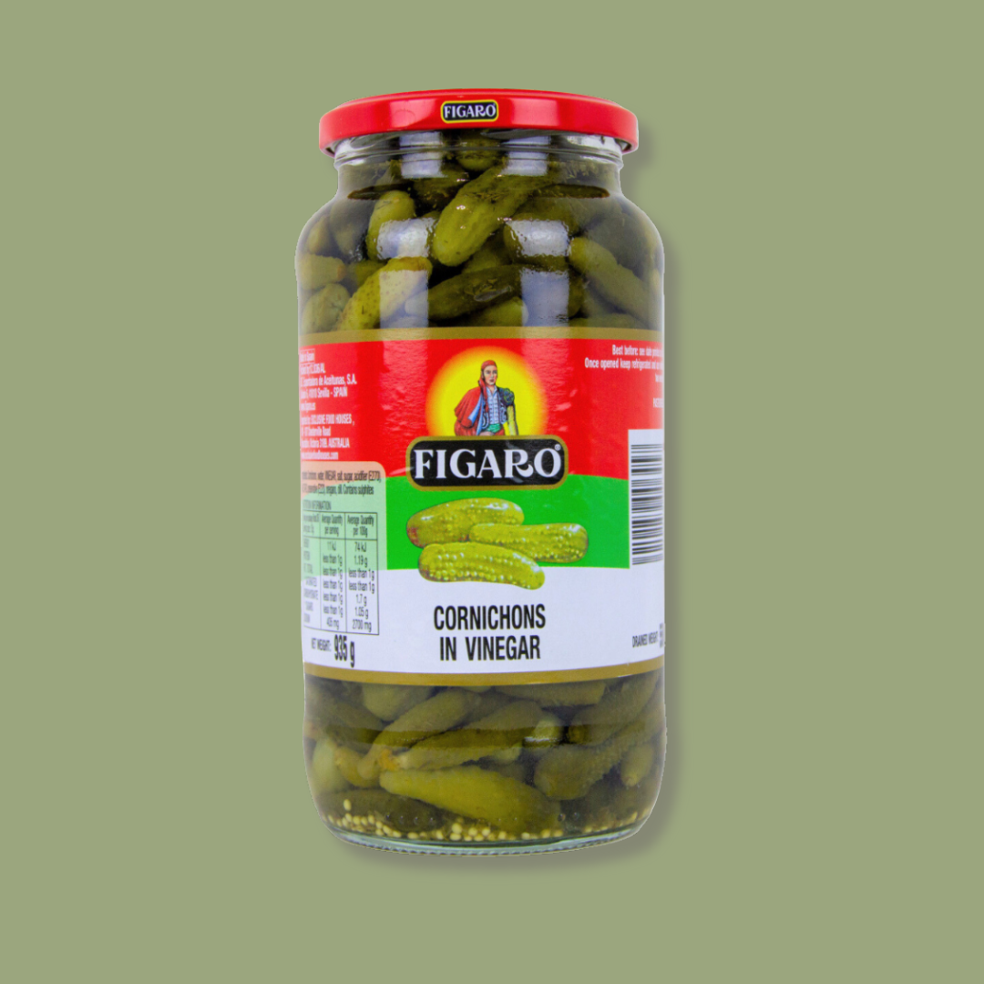 Jar of Figaro cornichons in vinegar on a green background
