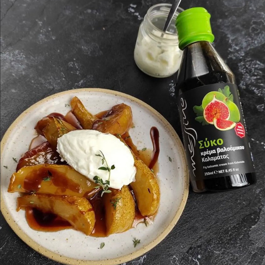 Plate of food with a bottle of syrup on a dark surface