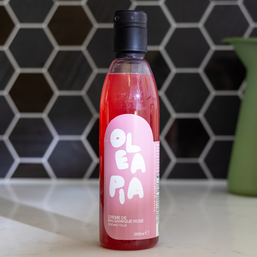 Bottle of OLEA PA on a kitchen counter with a hexagonal tile backsplash.