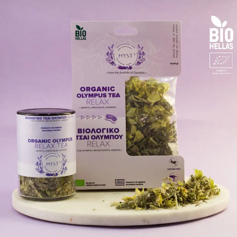 Organic Olympus Tea Relax packaging and loose tea on a white surface with a purple background