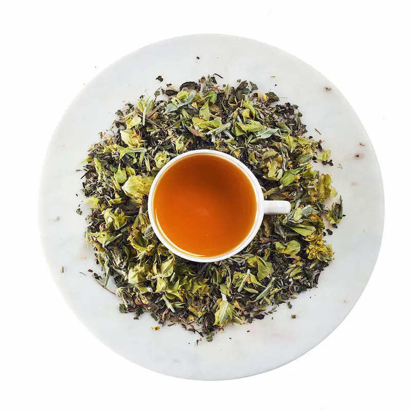 Tea cup with green tea leaves on a white background