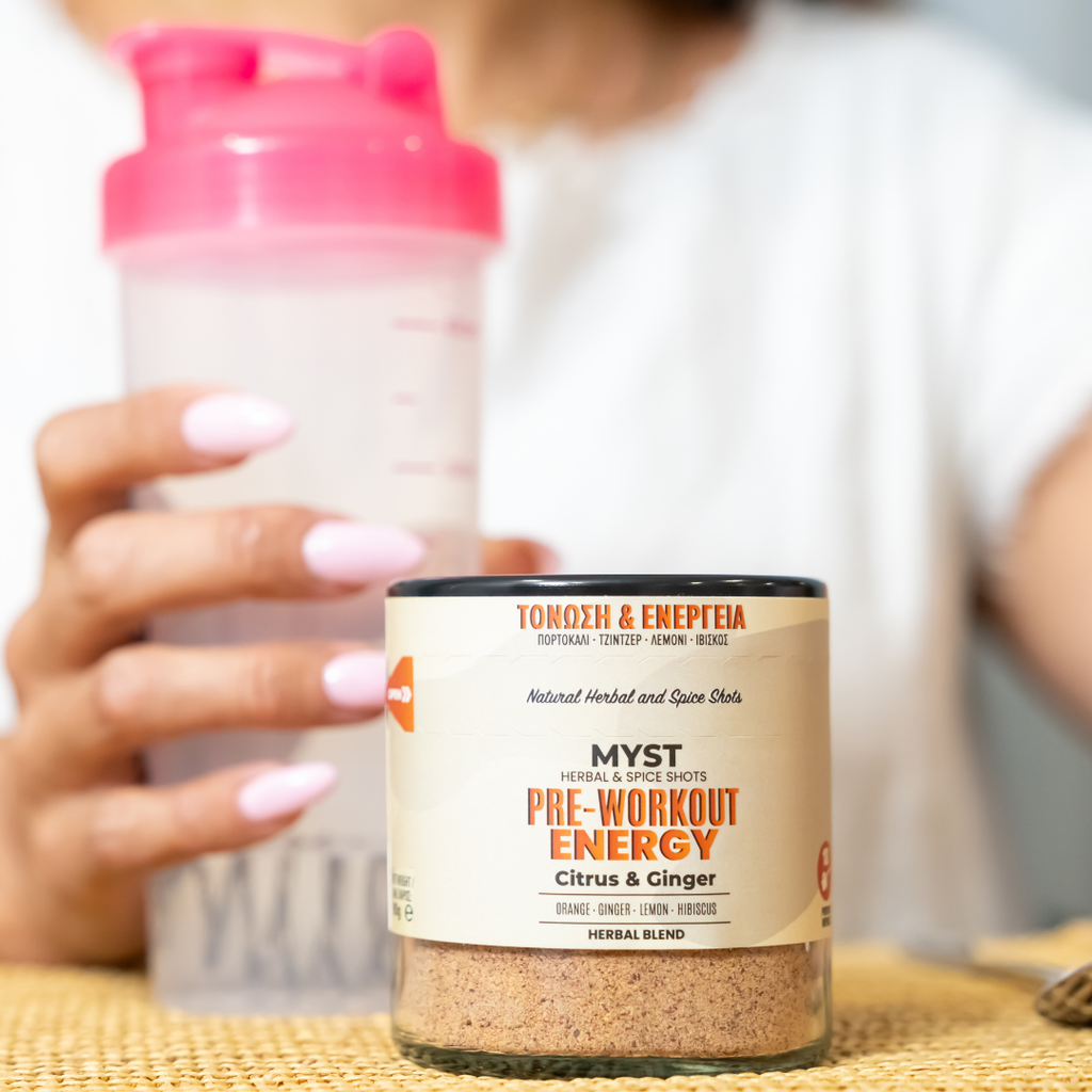 Pre-workout energy supplement container with a pink shaker bottle in the background