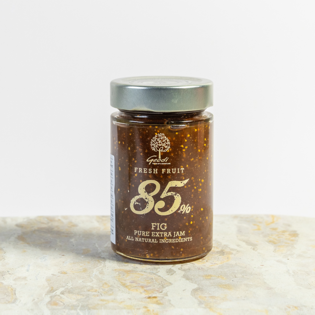 Jar of fig jam with a visible brand logo on a light background