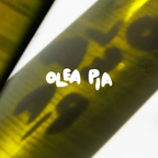 Close-up of a yellow bottle with 'OLEA PIA' text on a white background