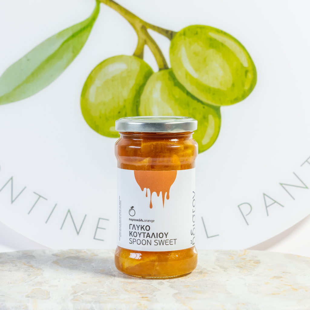 Jar of spoon sweet with a white label on a light background