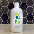 White bottle with colorful text on a tiled wall background