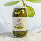Jar of pickled caper leaves with a label on a light background