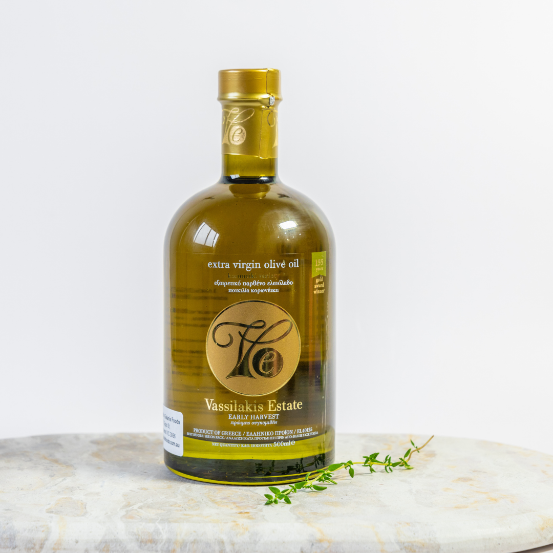 Bottle of Vassilakis Estate extra virgin olive oil on a marble surface with a white background