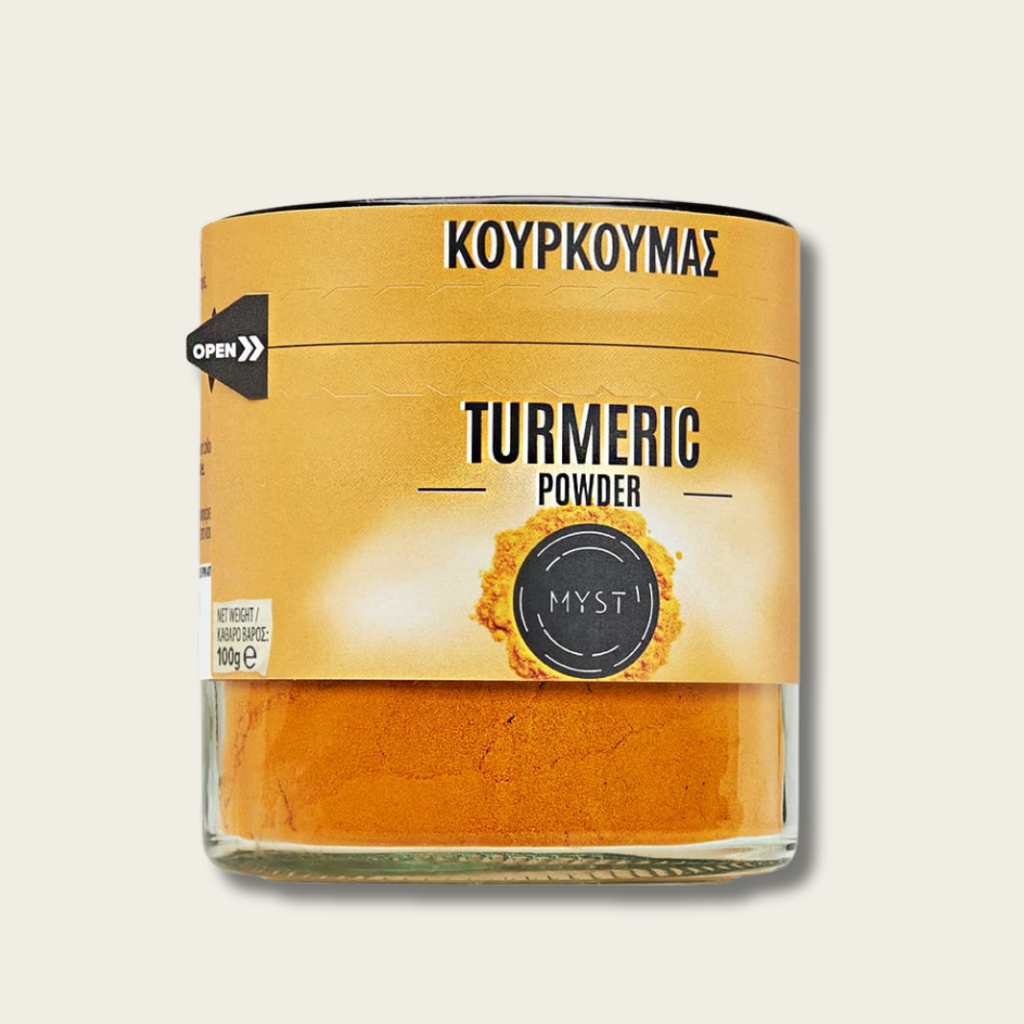 Jar of turmeric powder with a yellow label on a light gray background