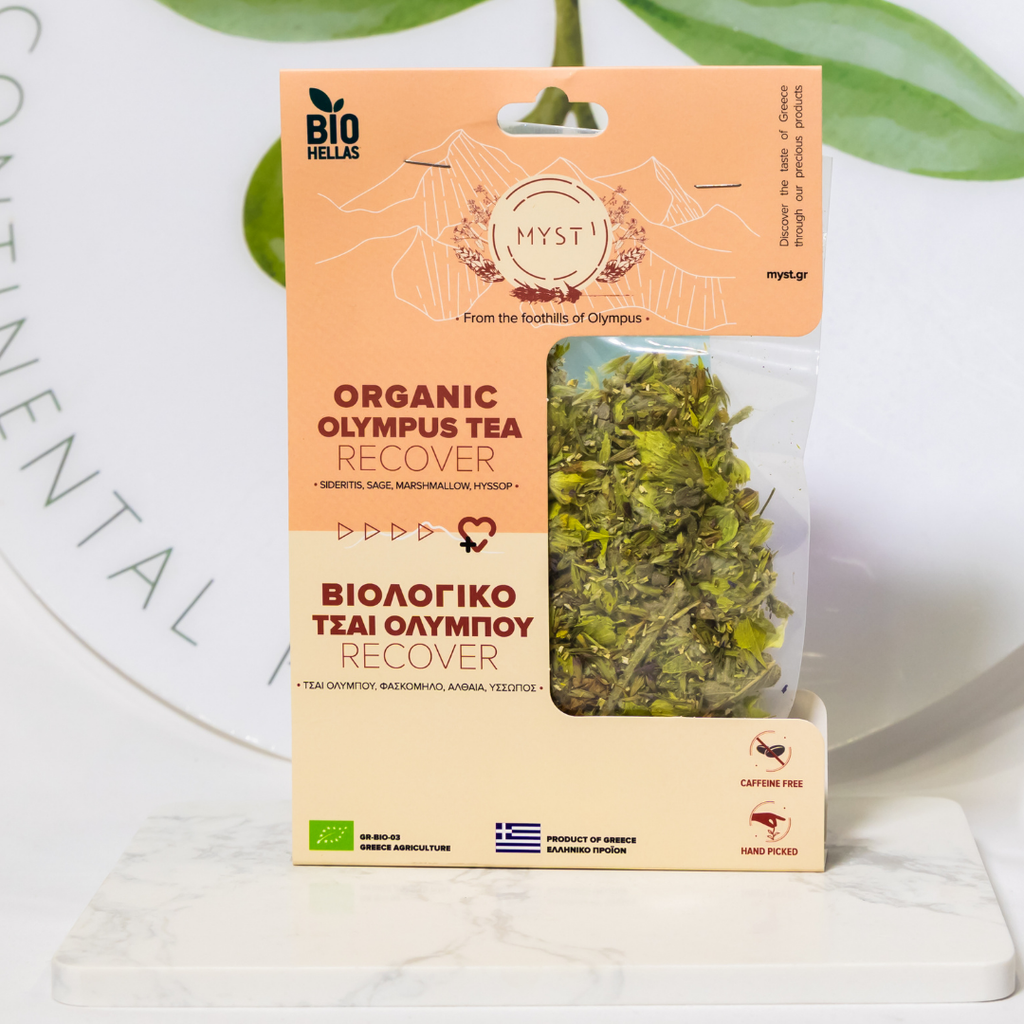 Package of Organic Olympus Tea Recover with green tea leaves on a white background