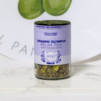 Jar of Organic Olympus Relax Tea with a purple label on a white surface.