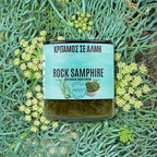 Jar of rock samphire with a label on a background of greenery