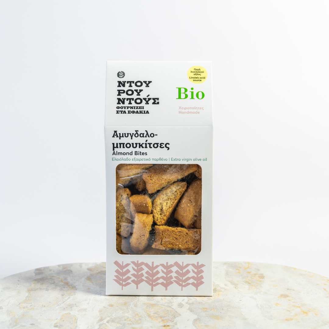 Packaged almond bites with branding on a marble surface