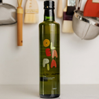 Bottle of OLA PA olive oil with kitchen utensils in the background