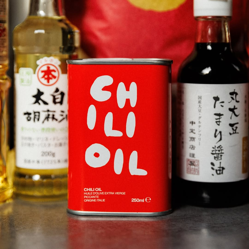 Red can of chili oil with bottles of other ingredients in the background