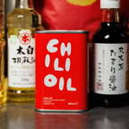 Red can of chili oil with bottles of other ingredients in the background