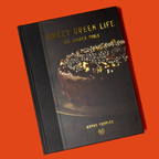 Book titled 'Sweet Greek Life: My Shared Table' with a cake illustration on an orange background