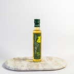 Bottle of Messina white wine vinegar on a marble coaster with a white background